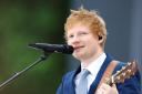 Ed Sheeran is donating a signed guitar (Hannah McKay/PA)