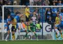 Ciaron Brown gets up to head away a Peterborough United cross