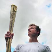 Cameron MacRitchie holds aloft the torch with which he lit the Olympic Cauldron at Friday’s Opening Ceremony. Picture: OX53453 Antony Moore