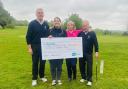 Men’s captain, Geoff Knight, and ladies captain, Jill Thompson, presenting the cheque to Fern Pilutkiewicz, head of hospice fundraising at Sue Ryder