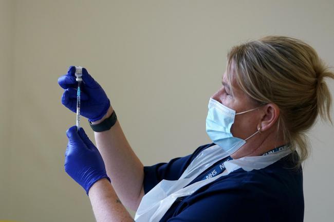 A nurse prepares to administer a Covid-19 vaccination