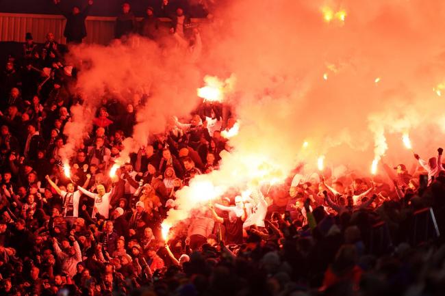 Legia Warsaw fans in the stands set off flares during the Europa League match