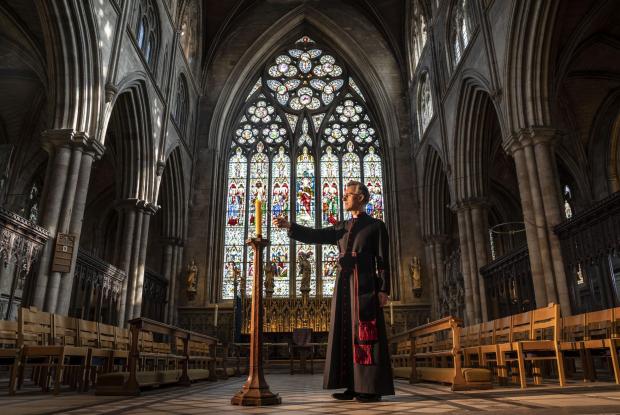 thisisoxfordshire: Very Reverend John Dobson Dean of Ripon lights a candle to mark the second anniversary of the first national coronavirus lockdown at Ripon Cathedral, North Yorkshire, ahead of the National Day of Reflection on Wednesday (PA)