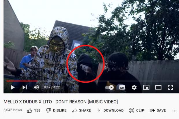 thisisoxfordshire: Amusan said he may have come into contact with the £50 notes during the filming of a music video, which was posted to YouTube a month before the alleged robbery; circled, the man Amusan picked out as himself Picture: YOUTUBE
