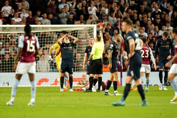 Burnley’s Matt Lowton reacts as he is shown a red card