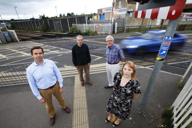 thisisoxfordshire: County councillors Calum Miller, Les Sibley, Michael Waine and Donna Ford at the London Road level crossing. Picture: Ed Nix