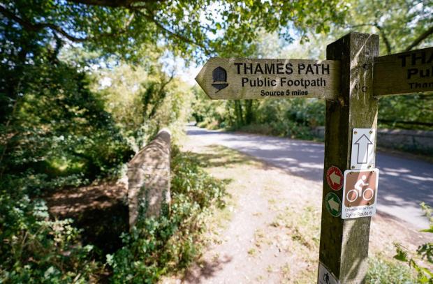 thisisoxfordshire: A view of a signpost for the Thames Path near to Somerford Keynes. Picture: Andrew Matthews/PA