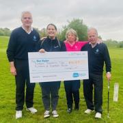 Men’s captain, Geoff Knight, and ladies captain, Jill Thompson, presenting the cheque to Fern Pilutkiewicz, head of hospice fundraising at Sue Ryder
