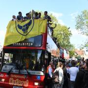 Oxford United players enjoy the open-top bus parade