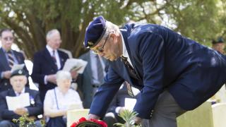 Major John Howard's second cousin Derek Chivers lays a wreath at his grave. Picture Damian Halliwell
