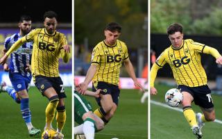 Josh Murphy, Mark Harris and Tyler Goodrham in action for Oxford United